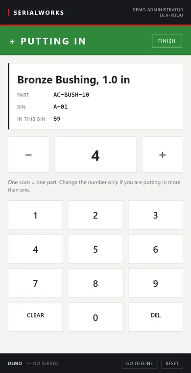 The floor scanner on a phone: a scanned part shown with its code and bin, and a keypad to confirm the quantity.